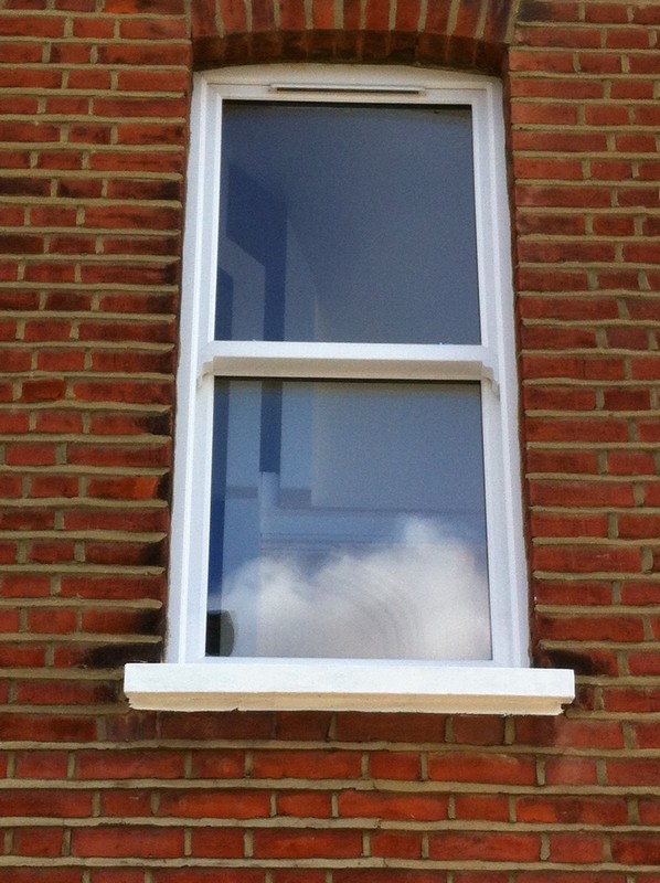 uPVC sash window on Victorian red brick house in Holloway